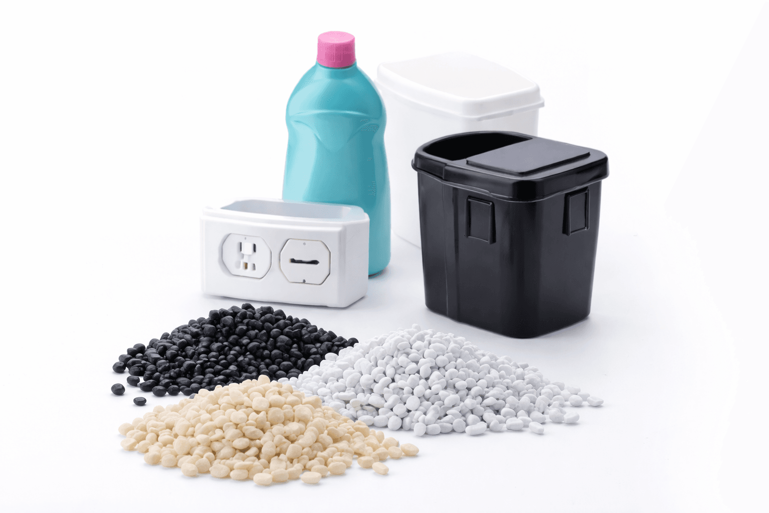 Piles of colored commodity resin pellets beside molded plastic parts