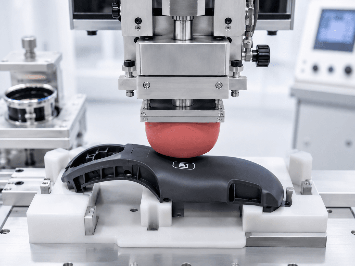 Pad printed logo on a curved molded plastic housing