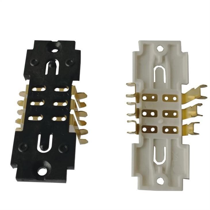 Black and white molded terminal carriers holding rows of gold plated metal contacts